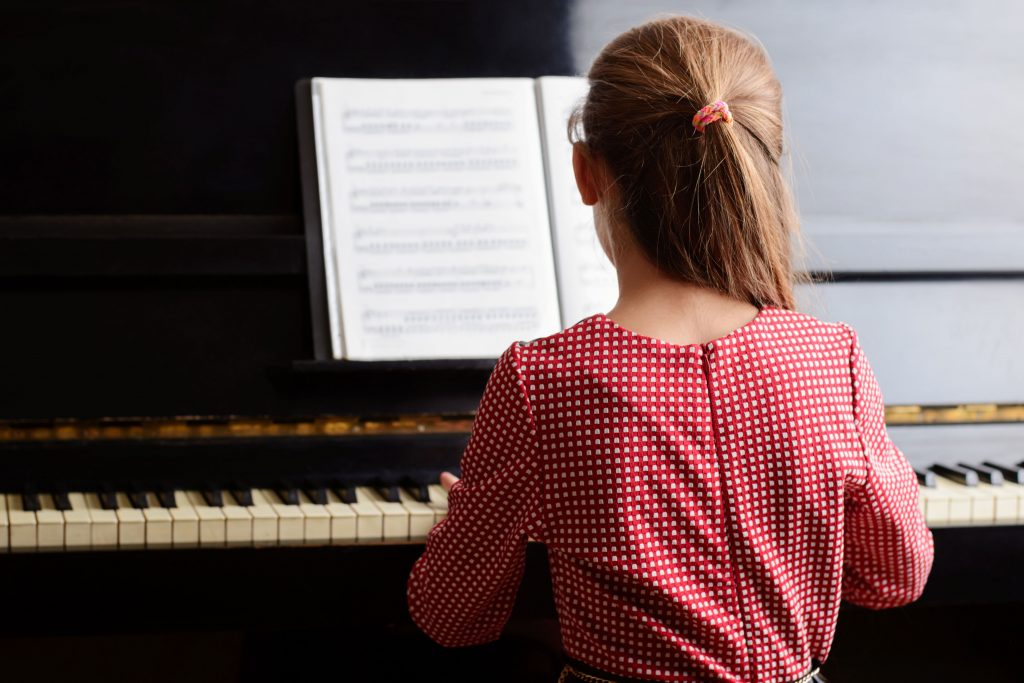 kid playing piano